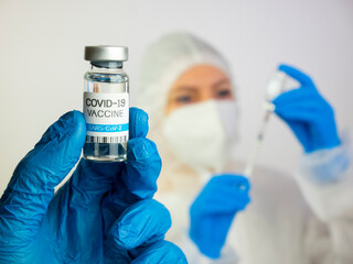 Covid-19 vaccine concept. Doctor holds covid-19 vaccine bottle in hand, close up. Vaccination...