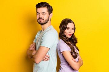 Obraz premium Profile side view portrait of attractive cheerful content couple folded arms isolated over bright yellow color background