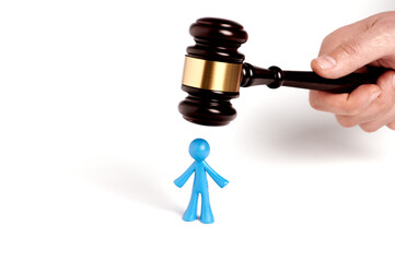 . Toy man and judge gavel isolated on white background. The concept of unfair judgments. Antipopular court. injustice - obrazy, fototapety, plakaty