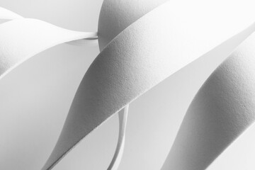 White curved elements with grainy background, abstract