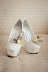 Wedding accessories: bride's shoes, rings and boutonniere