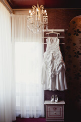 Bride's wedding dress is ready and waiting for the Bride and wedding ceremony in a Bride's room
