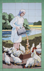 Attendant feeding chickens- panel from the ceramic tiles in the underpass
