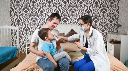 Fototapeta premium The doctor treats a child's runny nose