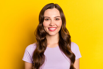 Portrait of attractive cheerful wavy-haired girl good mood isolated over vibrant yellow color background