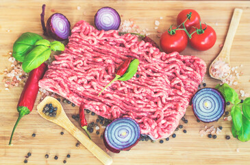 Ingredients for Lasagna or Bolognese Sauce .Pork Mince ,Cherry Tomatoes, Red Onion and Basil on a...