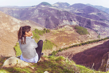 Young Woman Sitting above the  Mountain with Stunning View .Pirin Mountain ,Bulgaria   