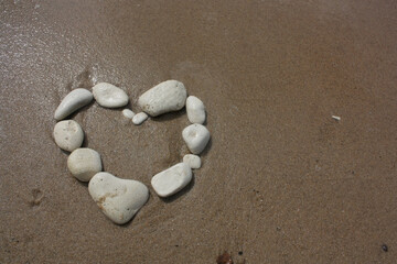 heart shaped stones on sand