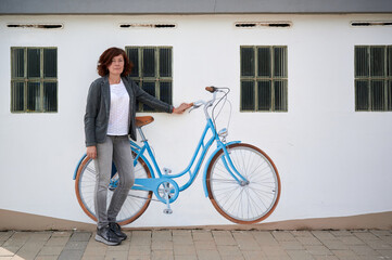 Fototapeta premium middle-aged woman with bicycle painted on a wall
