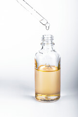 Brown glass bottles with drops Essential liquid in dropper. Selective focus. Focus on dropper.