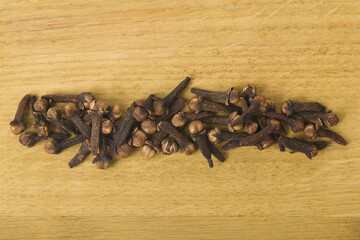 Spice cloves on a wooden table close-up.