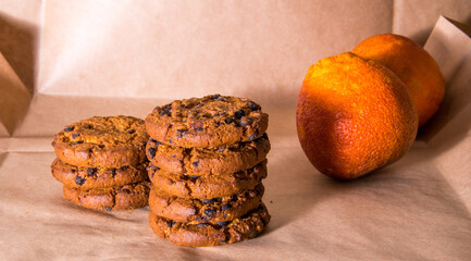 Cookies with chocolate icing orange, on gray packaging paper, copy space, template