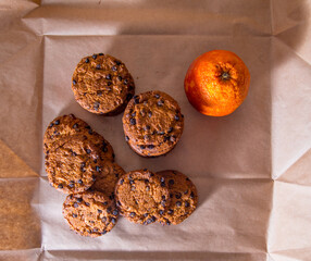 Cookies with chocolate icing orange, on gray packaging paper, copy space, template