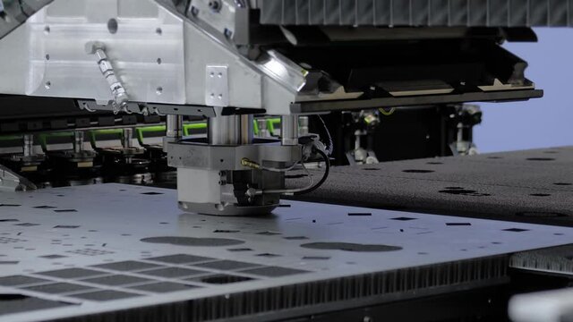 Automatic cnc hydraulic punching and shearing machine working with sheet metal at factory, plant. Metalworking, industrial, equipment, technology, machining, manufacturing concept