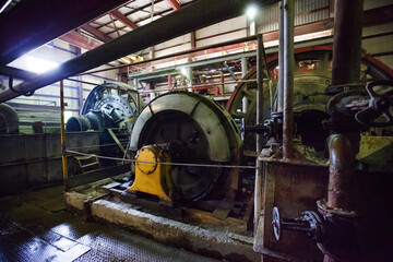 Mining and processing plant. Ball mills in factory workshop. Stepnogorsk, Kazakhstan.