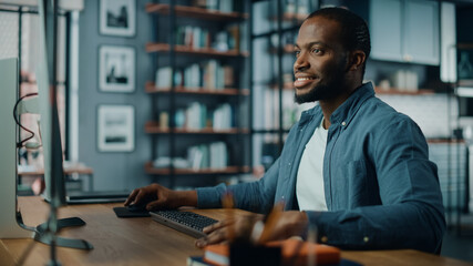 Handsome Black African American Specialist Working on Desktop Computer in Creative Home Living...