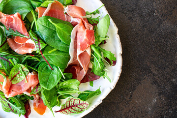 salad vegetable jamon prosciutto green leaves mix lettuce olives ham meat snack healthy meal top view copy space food background 