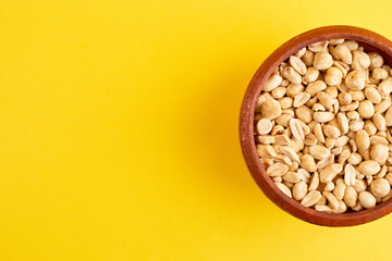 Nuts bowl on yellow background. Healthy vegan food.