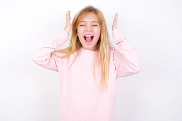 Beautiful caucasian blonde little girl wearing pink sweater goes crazy as head goes around feels...
