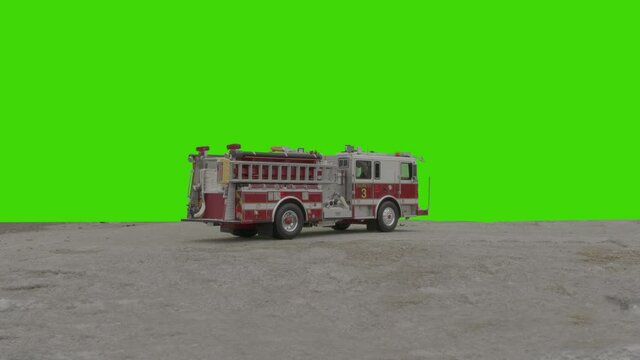 CHROMA KEY Overcast daytime shot, back side view of firefighter vehicle standing with flashing lights against green background