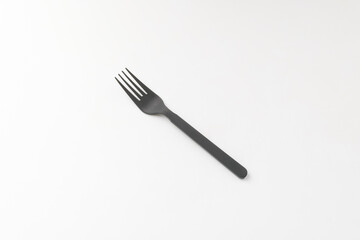 Plastic fork on white background