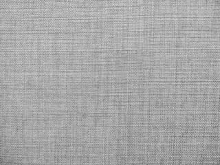 Selective focus of gray textured fabric. Macro shot of gray upholstery for furniture. Wallpaper and background. Closeup grey fabric texture. Thick gray material for the interior.
