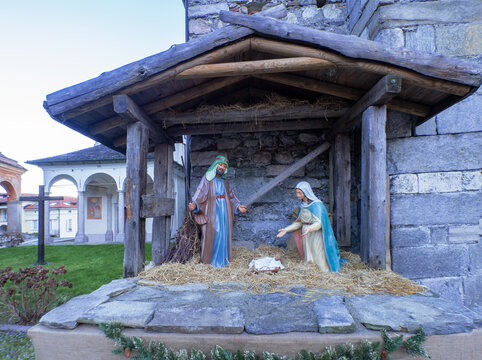 wooden hut with nativity scene set up in the parvis of a Romanesque church