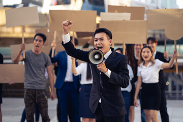 Group of activists with banners protesting to democracy and equality. Men and women doing a silent...