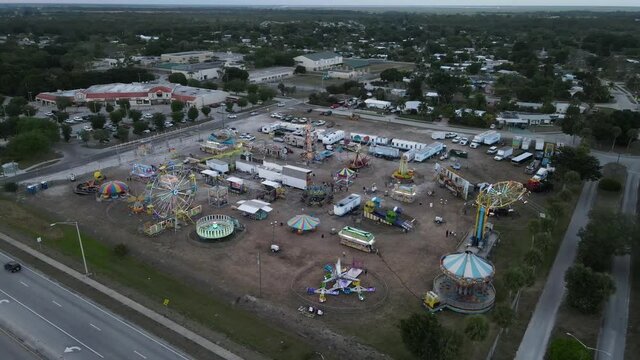 impressive drone clip of an old fashioned traveling carnival county fair-style near dark
