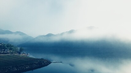 village and mountains in the mist in the morning