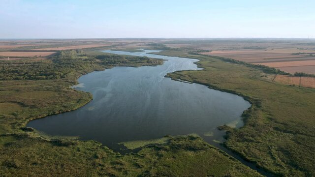 Aerial fly above beautiful lake. A picturesque lagoon - lake Shabla in the north-eastern Bulgaria, which separated from the Black Sea by the sandbar..