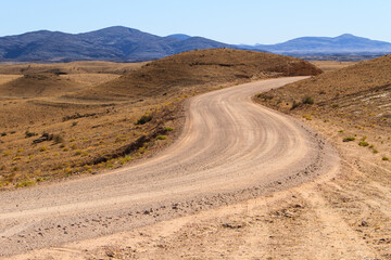 Fototapeta na wymiar Gravel road through namib desert in Namibia