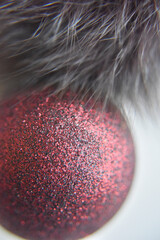 selective focus at the red ball with glitters on the surface with the fur
