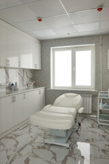 a couch, a bed in the cosmetology room, cabinets and marble tiles