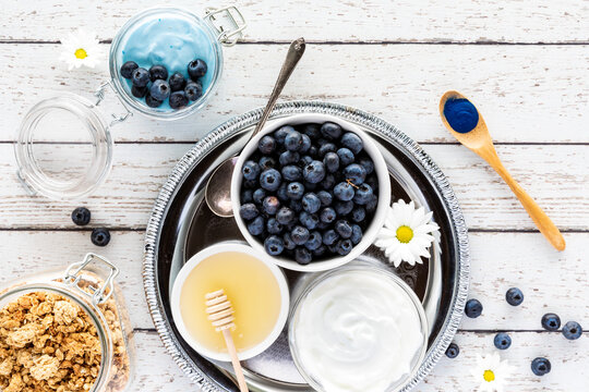 Top Down View Of A Tray Of Ingredients Used In Making A Blue Spirulina Yogurt Parfait.