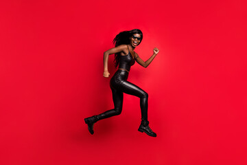 Fototapeta na wymiar Full length body size profile side view of funky girl wear leather suit jumping running action isolated on bright red color background
