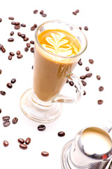 Close-up view of the Crema Coffee cappuccino  In a clear glass and coffee beans on white background.shallow focus effect.