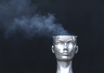 mannequin head smokes on black background