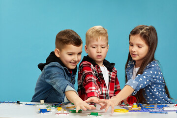 children playing with electronic constructor at studio