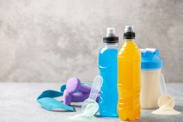 Different sport drinks in bottles - L-carnitine, isotonic and protein shake. Fitness concept.