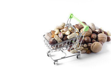 A cart full of different nuts and a mountain of nuts on a white background of assorted nuts	
