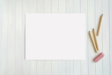 Blank horizontal paper sheet and pencils on wooden background, US letter size coloring page,...
