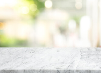 Selective focus.Marble table top on blur glass wall background