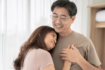 Fototapeta premium Asian elderly couple, Couple is enjoying spending time together at home, lockdown and quarantine lifestyle.