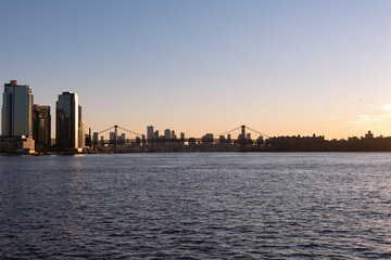Naklejka premium Sunset along the East River with the Williamsburg Bridge in New York City