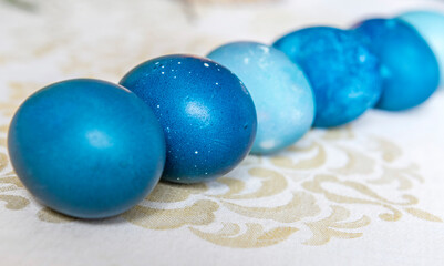 Natural dyed blue colored Easter eggs on the table close-up. Happy Easter.