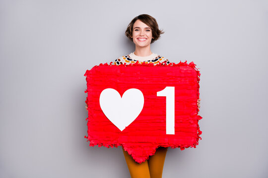 Portrait of lovely cheerful girl holding big board like smm one count isolated over grey pastel color background