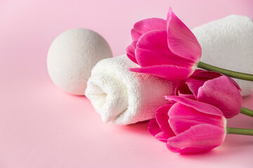Spa skin care products on a pink background. Natural cosmetics and red tulips.
