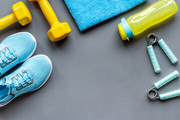 Athlete equipment with dumbbells and sneakers. Overhead view