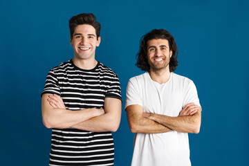 White brunette two men looking and smiling at camera